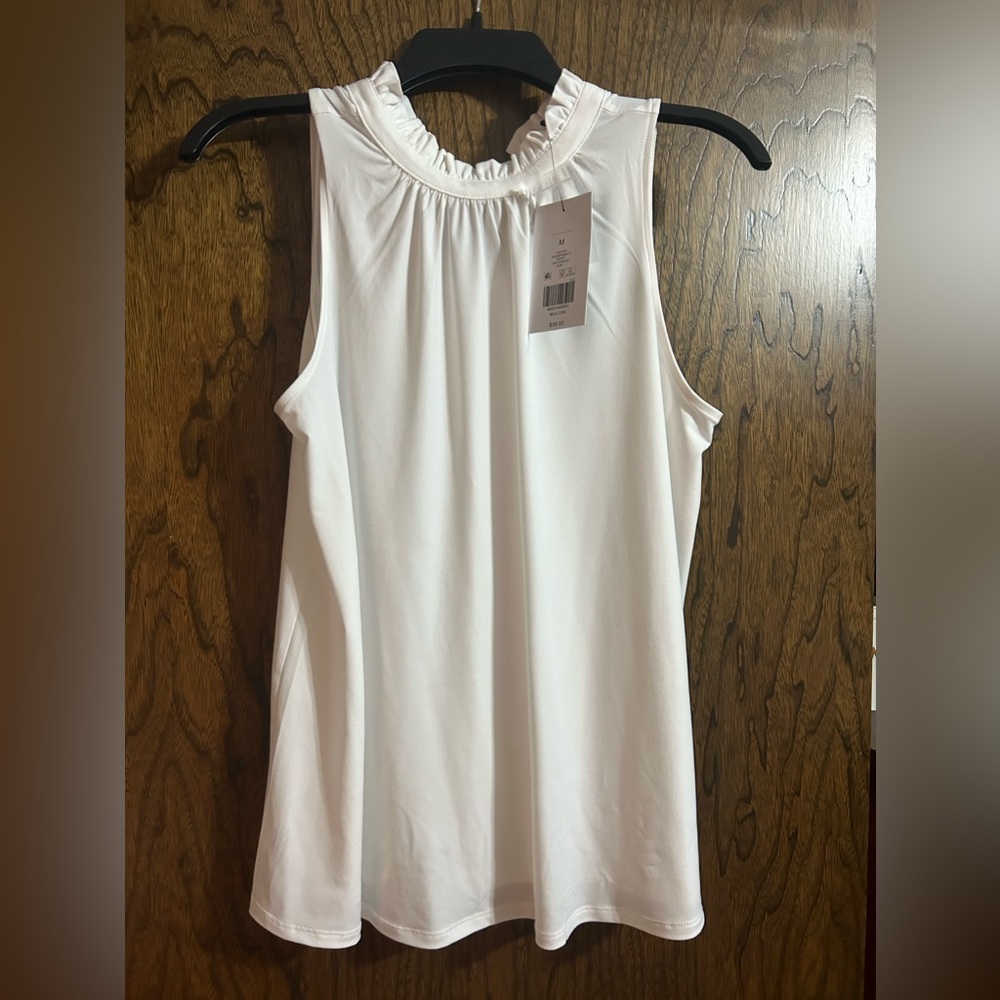 White flowy tank top with ruffle detailing in neckline- new with tags.